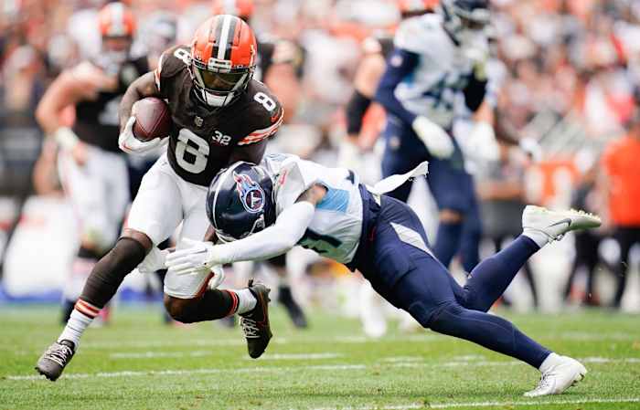 Tennessee Titans safety Amani Hooker (37) tackles Cleveland Browns wide receiver Elijah Moore (8) during the second quarter in Cleveland, Ohio.